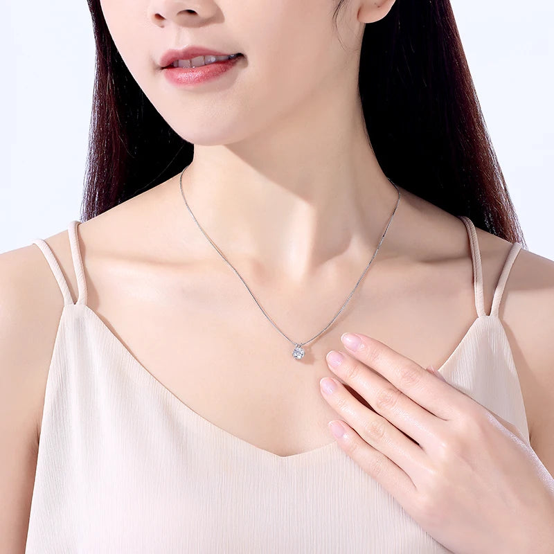 Moissanite pendant necklace worn on a model