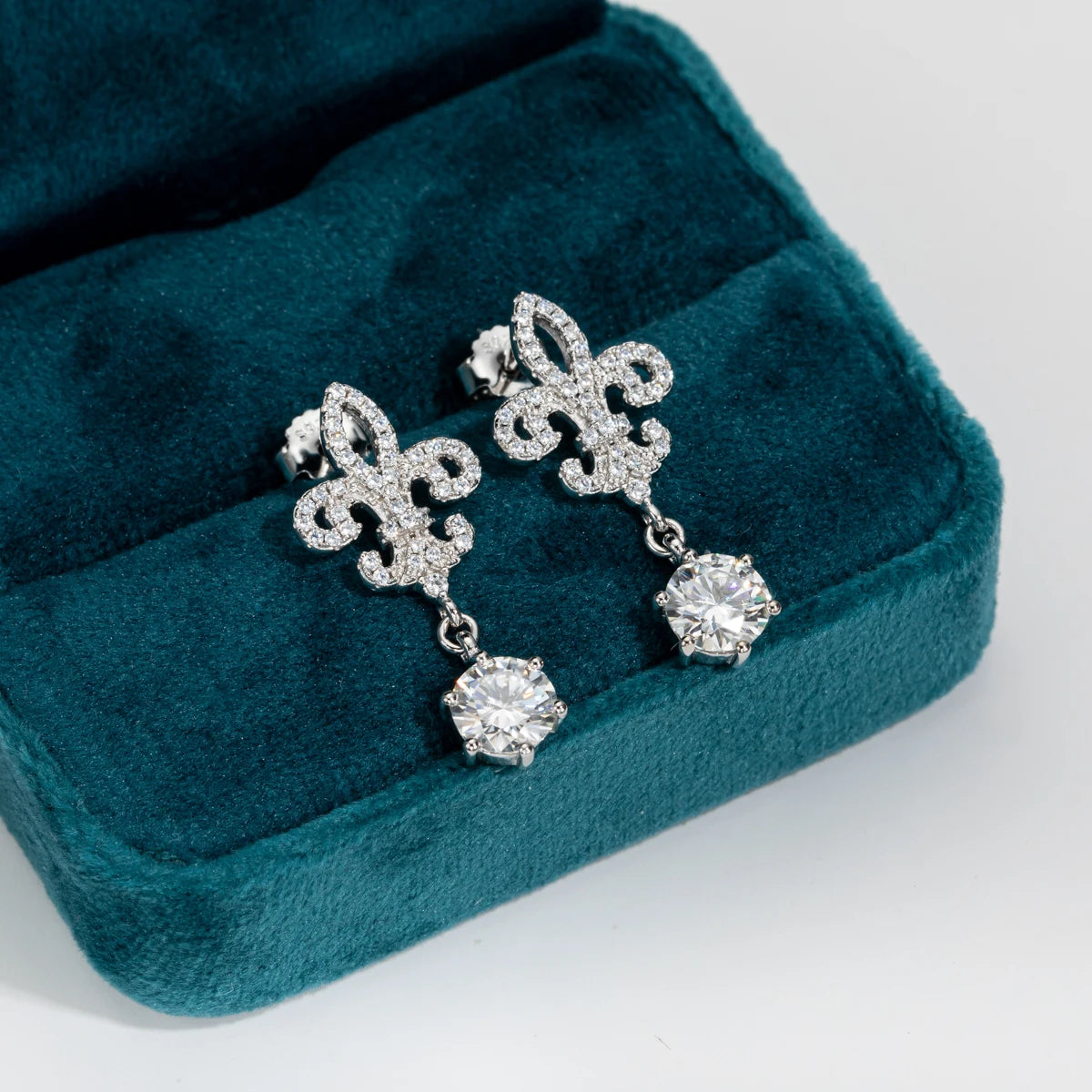 Drop earrings displayed in an elegant jewelry box