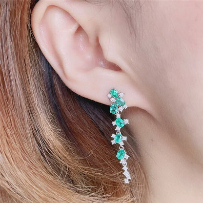 Woman wearing natural emerald earrings