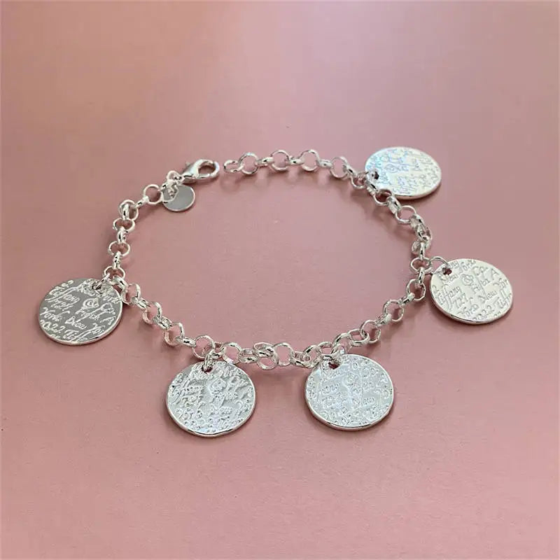 Close-up of round pendant on bracelet