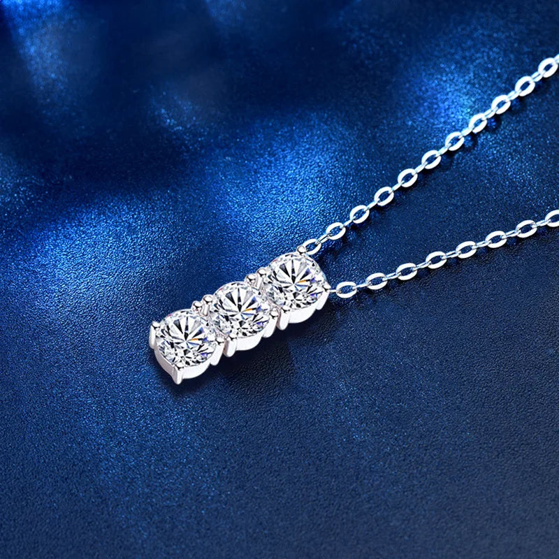 A photo of the necklace with a blue background