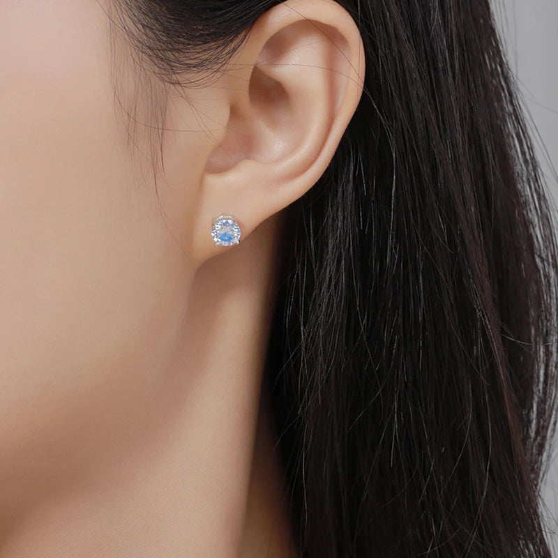 Woman wearing colorful moissanite screwback earrings